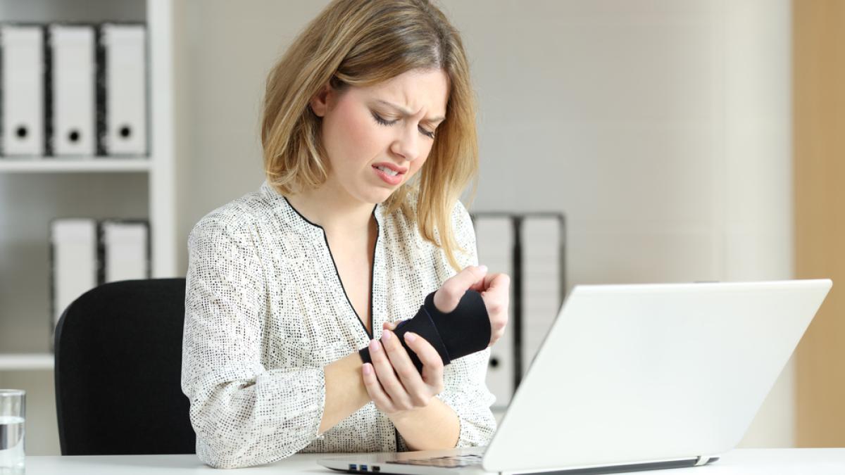 Woman in pain holding her wrist