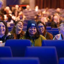 Attendees at CSP conference 2026- sitting in auditorium laughing and relaxed