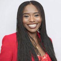 Dr Yetunde Dairo smiling at the camera. She is wearing a red top.