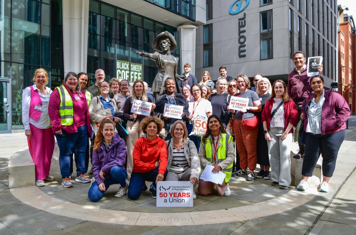 CSP members standing by the Emeline Pankhurst statue in Manchester on a walking fringe event